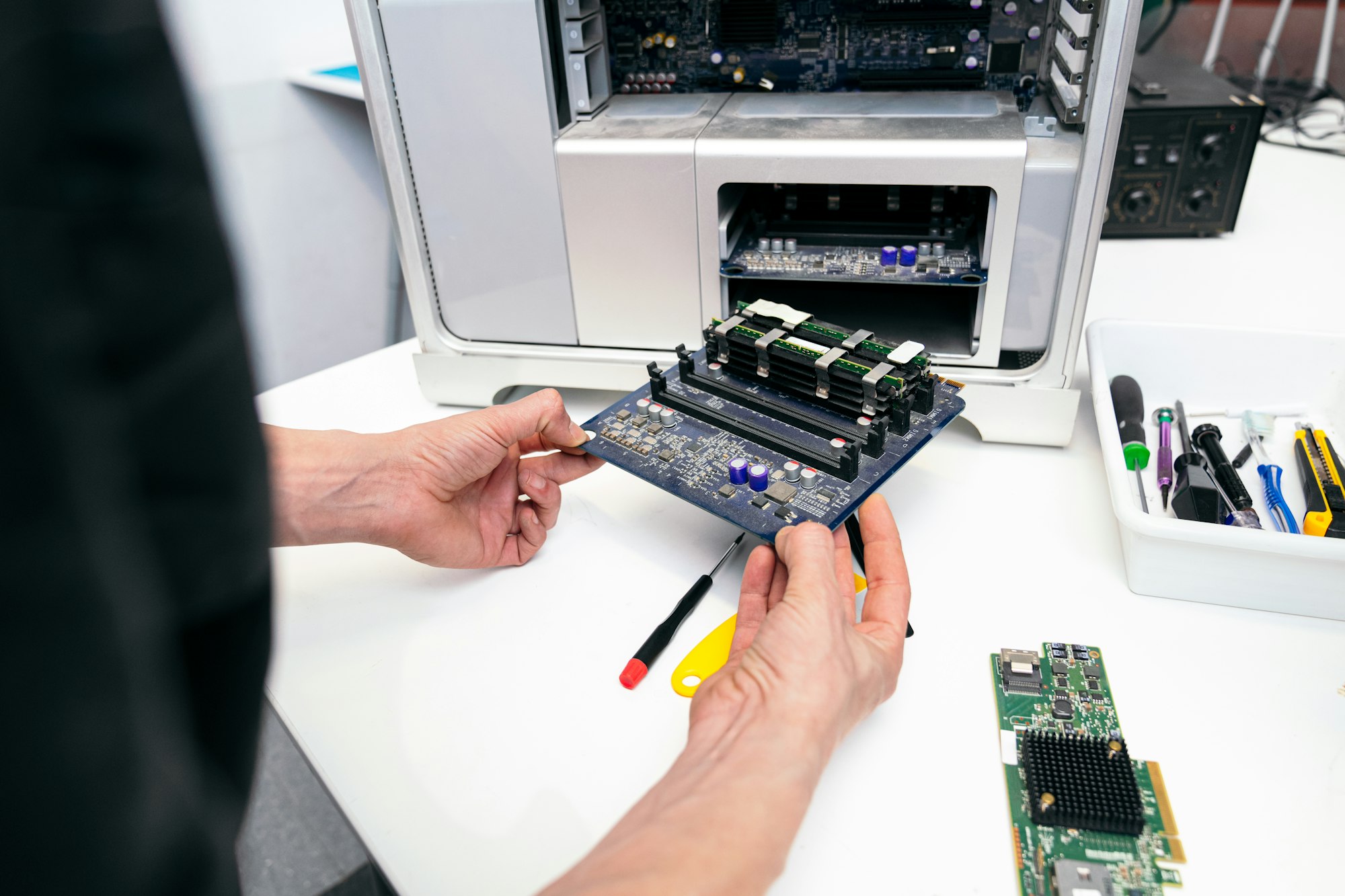 Technician Repairing RAM Module on Computer Motherboard