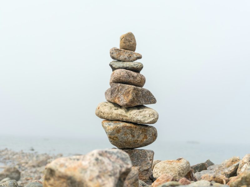 Stack of stones cairn on foggy beach